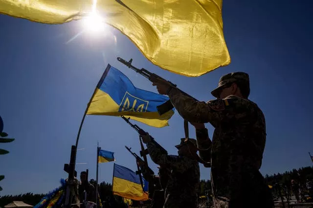 Honour guards shoot into the air during the funeral ceremony of six Ukrainian servicemen killed in a Russian rocket attack at a Ukrainian military academy