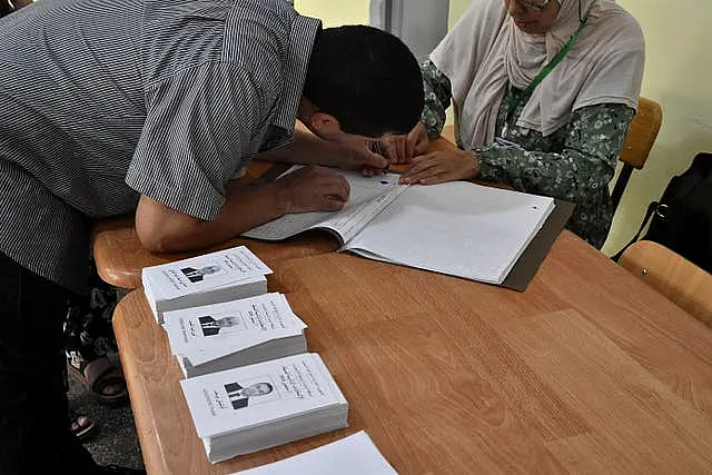 An election agent sorts out papers