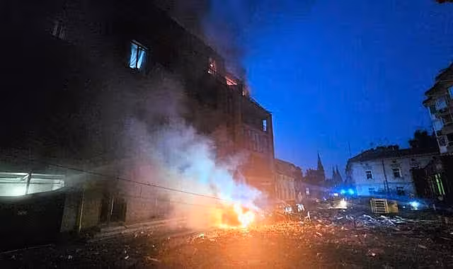 A car burns near a residential building damaged by a Russian strike in Lviv,