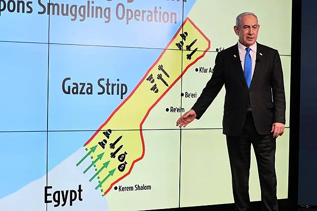 Benjamin Netanyahu gestures in front of a map