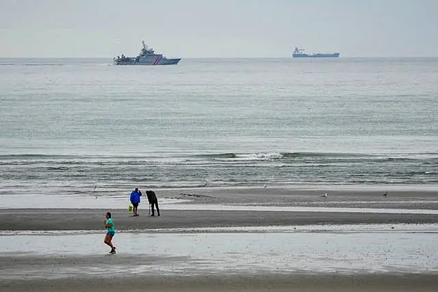 A vessel of the French Gendarmerie Nationale patrols in front of the Wimereux beach, France