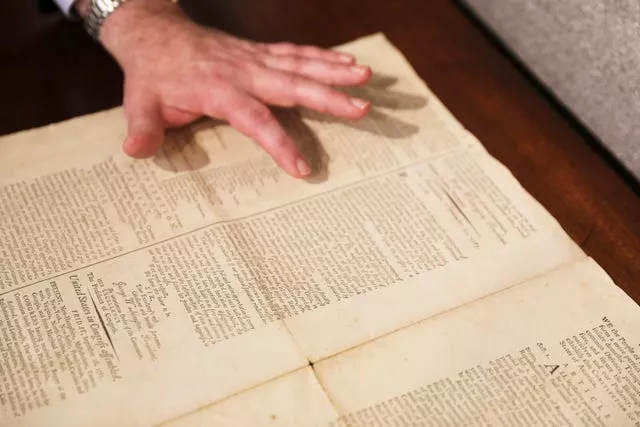 Hands pointing at the document