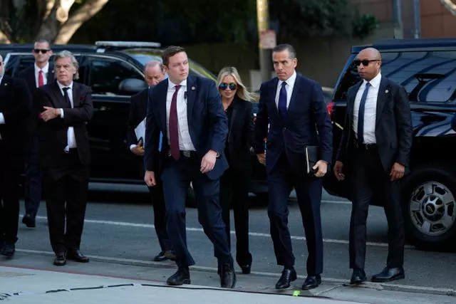 Hunter Biden flanked by several security officers