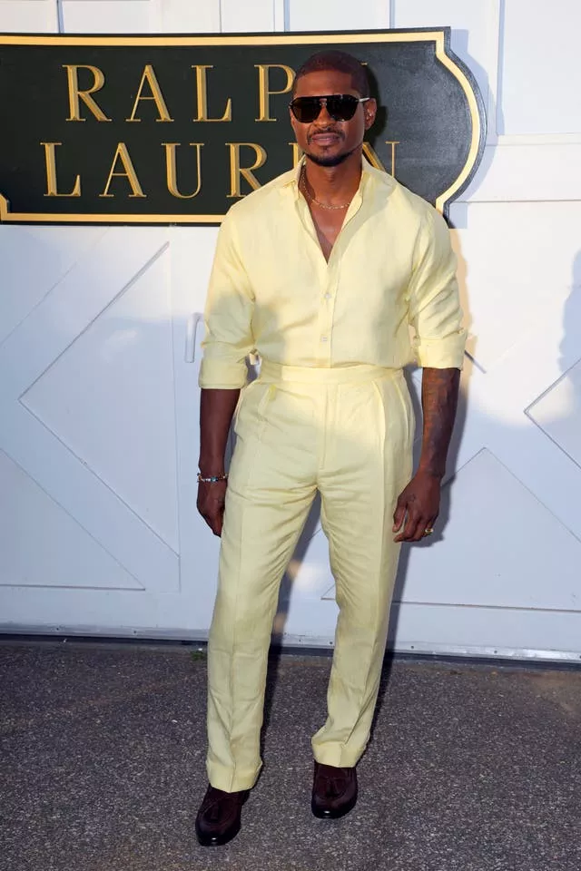 Usher poses in yellow shirt and trousers for NYFW S/S 2025 Ralph Lauren 