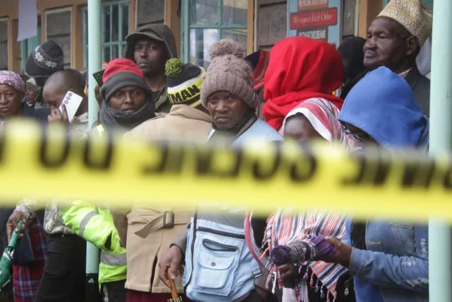 A group of people behind police tape