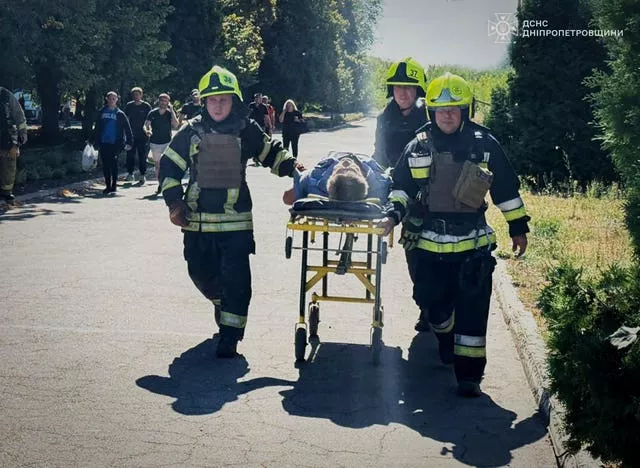 Emergency service workers help a civilian wounded in a Russian missile attack in Pavlohrad, Ukraine