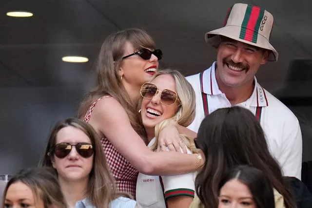 Taylor Swift hugs Brittany Mahomes as Travis Kelce looks on