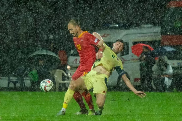 Vladimir Jovovic and Ben Davies battle for the ball