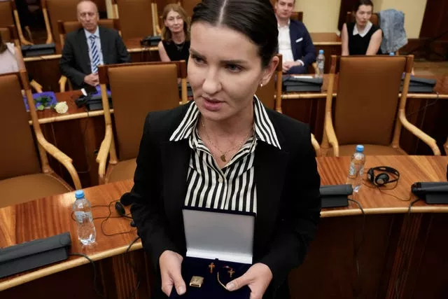 A relative shows amber crucifixes and jewelry that were confiscated by Nazi Germans from Stanislawa Wasilewska