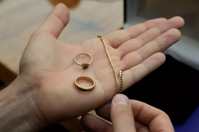 A relative shows golden jewellery that was confiscated by Nazis