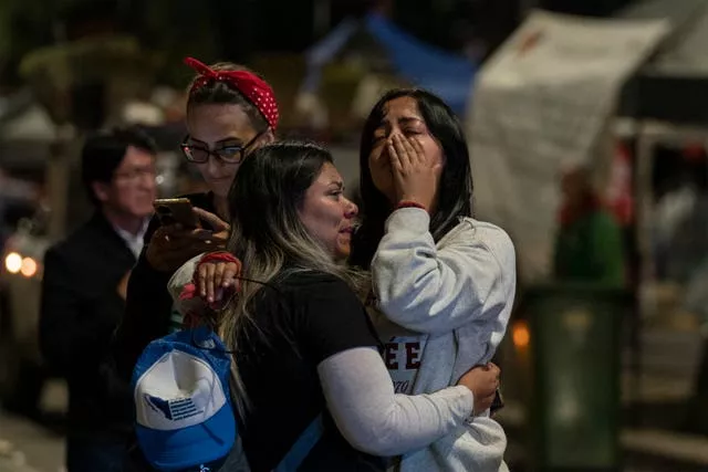 Two women cry after watching senators’ vote 