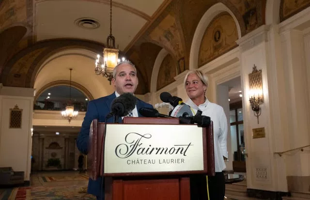 Fairmont Chateau Laurier general manager Genevieve Dumas looks on as Ottawa police detective Akiva Gellar speaks about the stolen portrait of Winston Churchill 