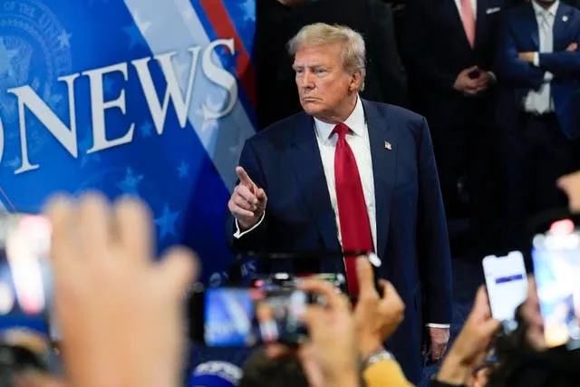 Donald Trump speaks to reporters in the spin room after the presidential debate