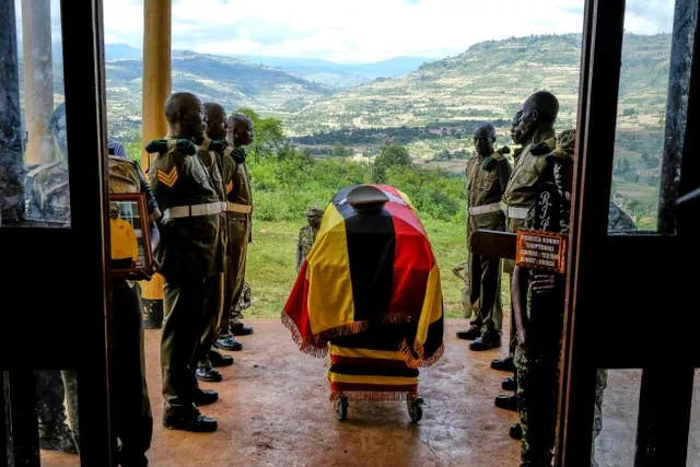 Members of Uganda People’s Defence Force (UPDF) stand at the casket of their colleague Ugandan Olympic athlete Rebecca Cheptegei ahead of her burial