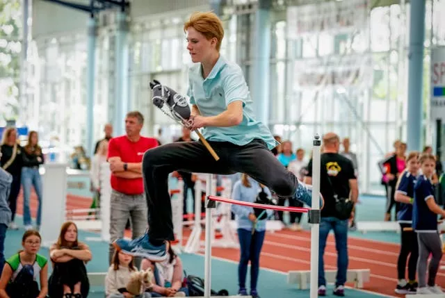 A participant clears the bar 