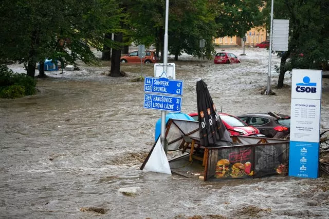 Flooded street, with damaged property