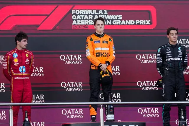 Oscar Piastri, centre, Charles Leclerc, left, and George Russell on the podium