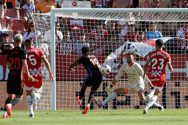 Lamine Yamal, centre left, scores Barcelona’s first goal against Girona