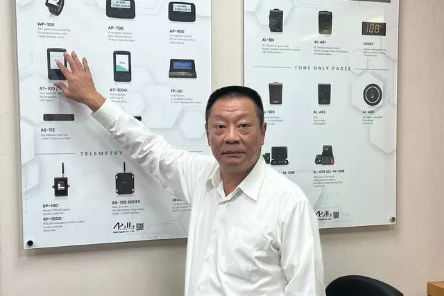 Hsu Ching-kuang, chairman of Apollo Gold, points to a picture as he talks about the company’s products