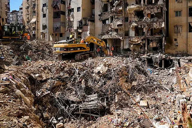 Rescuers sift through the rubble as they search for people still missing at the site of Friday’s Israeli strike in Beirut’s southern suburbs