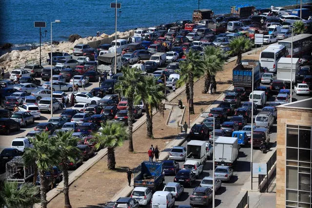 Cars sit in traffic as people flee the southern villages 