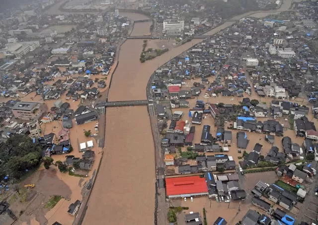 An aerial photo shows the flooded Kawarada river 