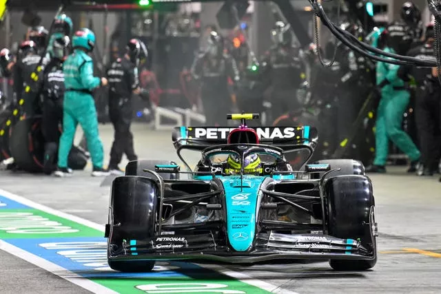 Mercedes driver Lewis Hamilton steers his car out of pit lane during the Singapore Grand Prix