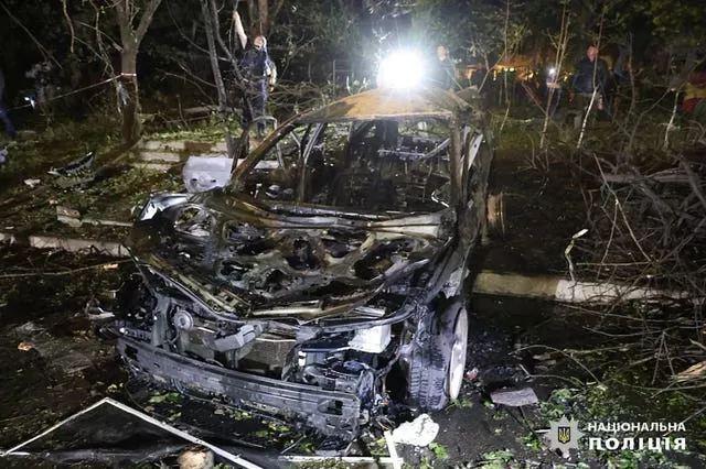 A light is shone on a damaged car 