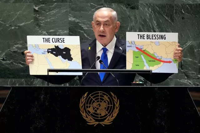 Israel Prime Minister Benjamin Netanyahu  holds up maps