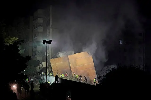 Rescuers at the site of an Israeli air strike in Beirut’s southern suburbs