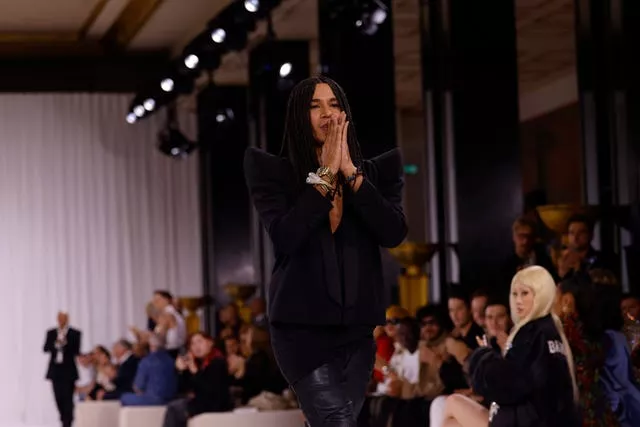 Designer Olivier Rousteing accepts applause after the Balmain Spring/Summer 2025 collection