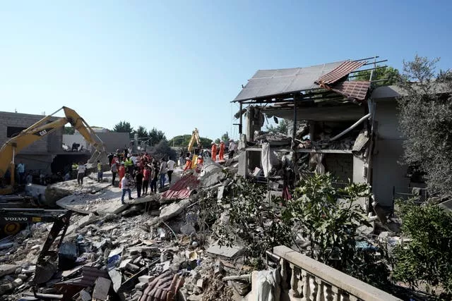 Emergency workers arrive at the scene of an Israeli air strike in the town of Maisara, north of Beirut