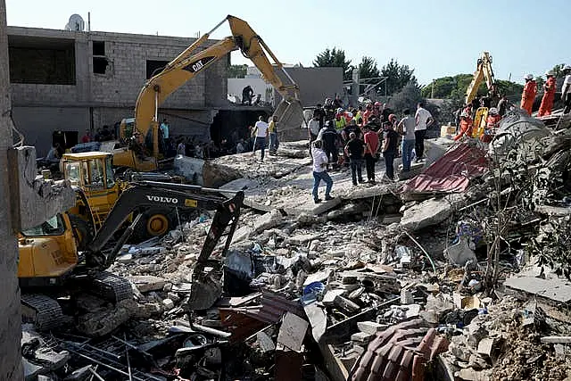 Emergency workers at the scene of an Israeli airstrike in the town of Maisara, north of Beirut