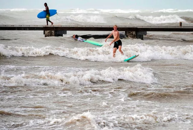 Surfers take advantage of heavy winds along Higgs Beach in Key West, Florida 