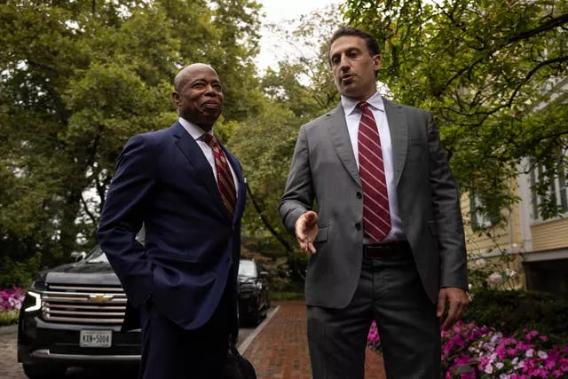 New York City mayor Eric Adams, left, and his lawyer Alex Spiro talk to members of the media as they exit Gracie Mansion, the official residence of the mayor, on Thursday in New York