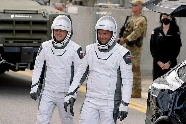 Nick Hague (right) and Aleksandr Gorbunov leave for their flight into space