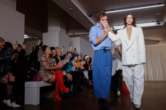 Designer Andreas Kronthaler, left, kisses the hand of Irina Shayk after the Vivienne Westwood Spring/Summer 2025 collection