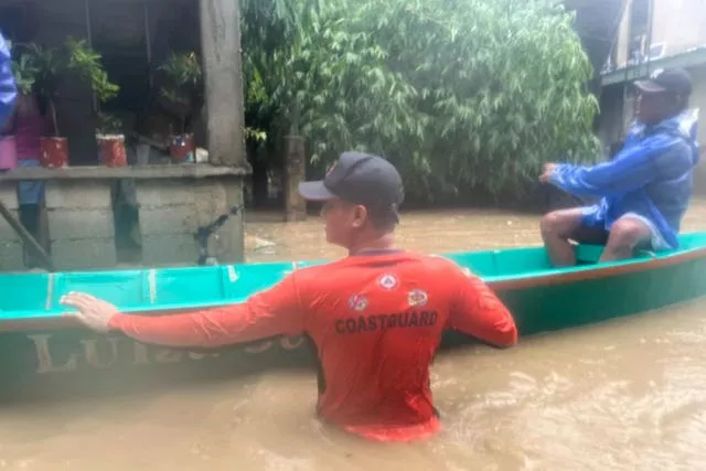 Rescuers use a boat to evacuate residents at a flooded village as powerful Typhoon Krathon affects Laoag, Ilocos Norte, northern Philippines