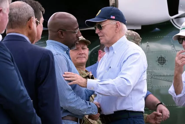 Joe Biden, right, shakes hands with senator Raphael Warnock in Georgia