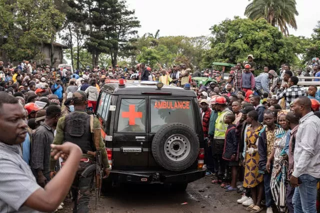 People surrounding an ambulance