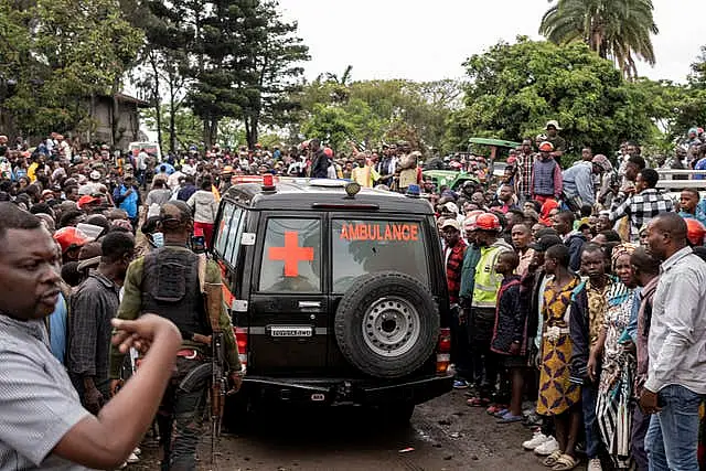 People surrounding an ambulance