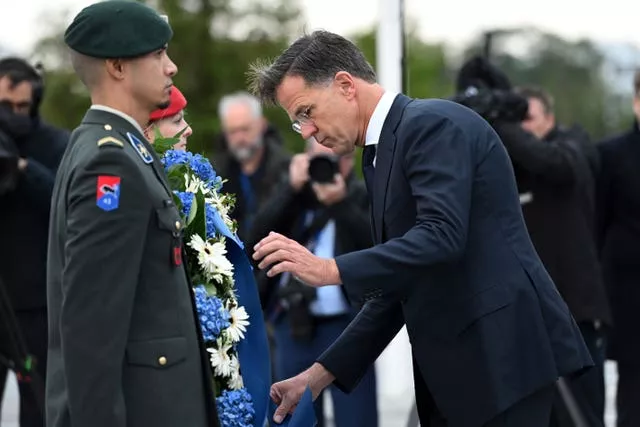 Incoming Secretary General Mark Rutte lays a wreath during a transition ceremony at Nato headquarters in Brussels, Belgium