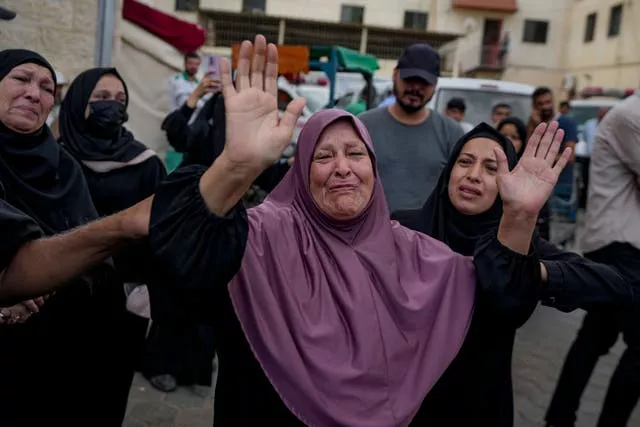 Palestinians mourn relatives killed in the Israeli bombardment of the Gaza Strip