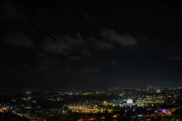 Projectiles fly through the sky over Jerusalem as a siren sounds a warning of incoming missiles fired from Iran, in Jerusalem, on Tuesday 