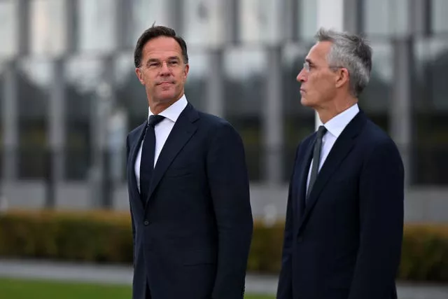 Incoming Nato Secretary General Mark Rutte, left, and outgoing Nato Secretary General Jens Stoltenberg stand during a wreath-laying ceremony at Nato headquarters in Brussels, Belgium 