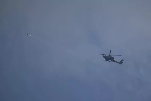 An Israeli Apache helicopter fires a missile towards southern Lebanon 