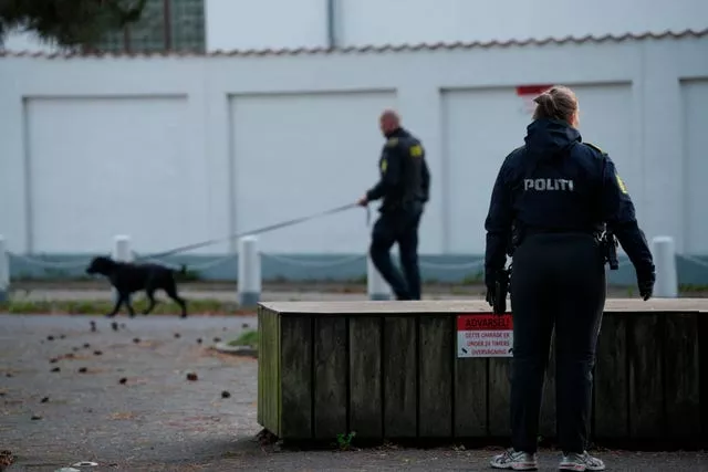 Two police officers with dogs near the Israeli embassy in Copenhagen