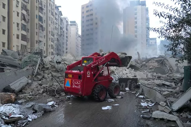 Civil Defence personnel remove debris from a destroyed complex hit by Israeli airstrikes in Dahieh, Beirut, Lebanon