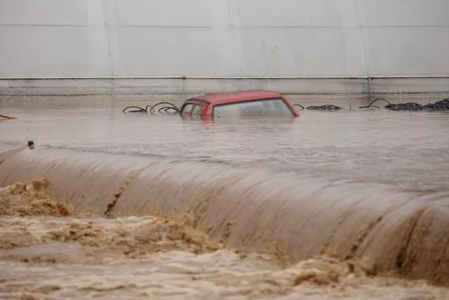 A car is submerged in floodwaters outside an apartment building in the village of Kiseljak, northern Bosnia