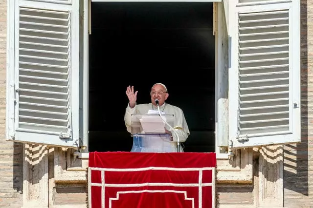 Pope Francis waves from his studio window